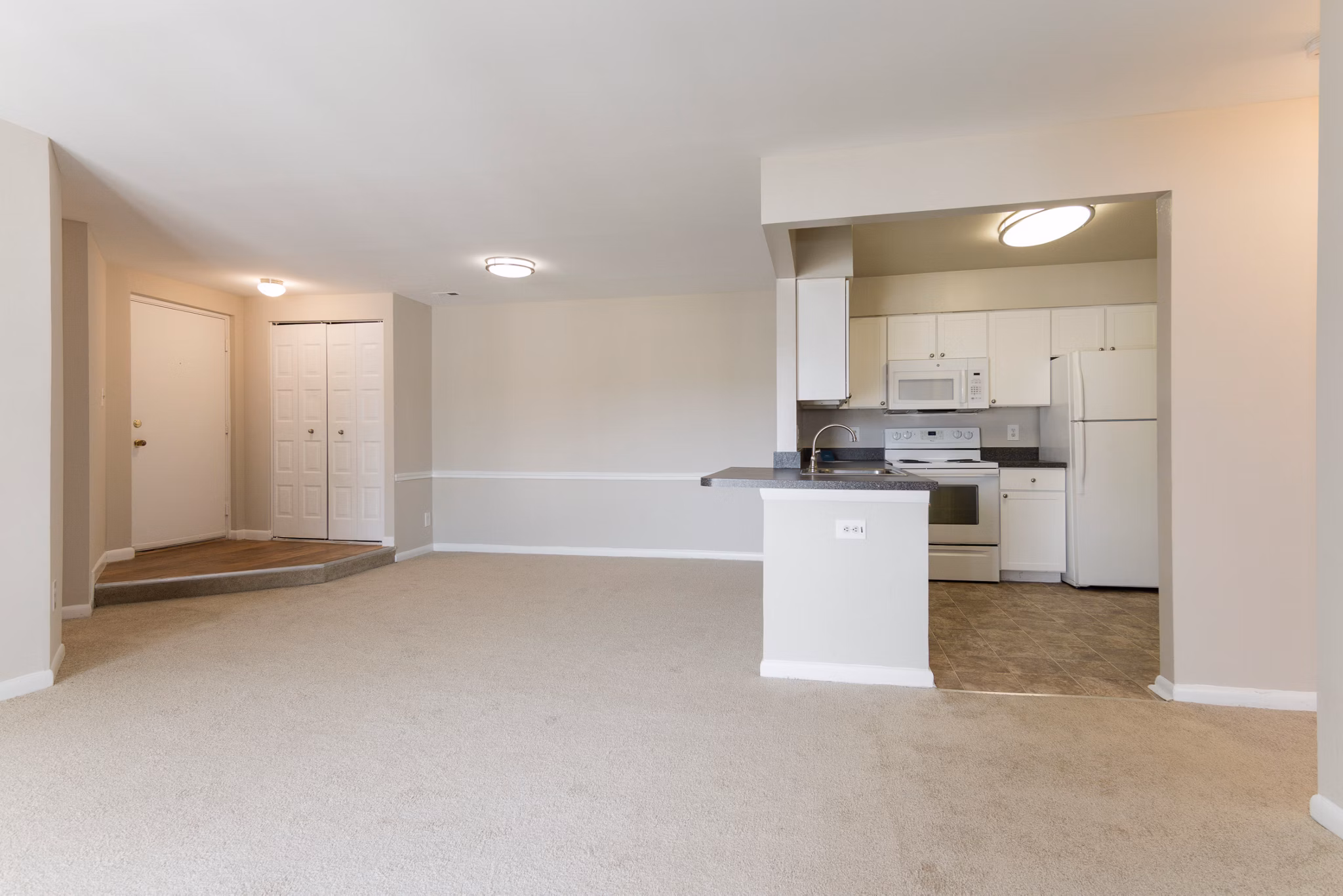 Spacious living room with contemporary furniture and light accents in Avana Oak Mill Apartments