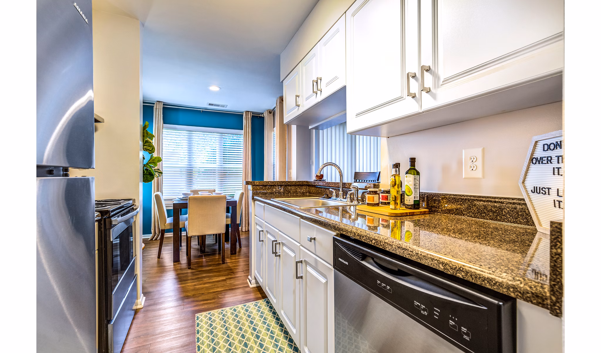 Modern kitchen with sleek countertops and stainless steel appliances at Avana Heather Ridge Apartments