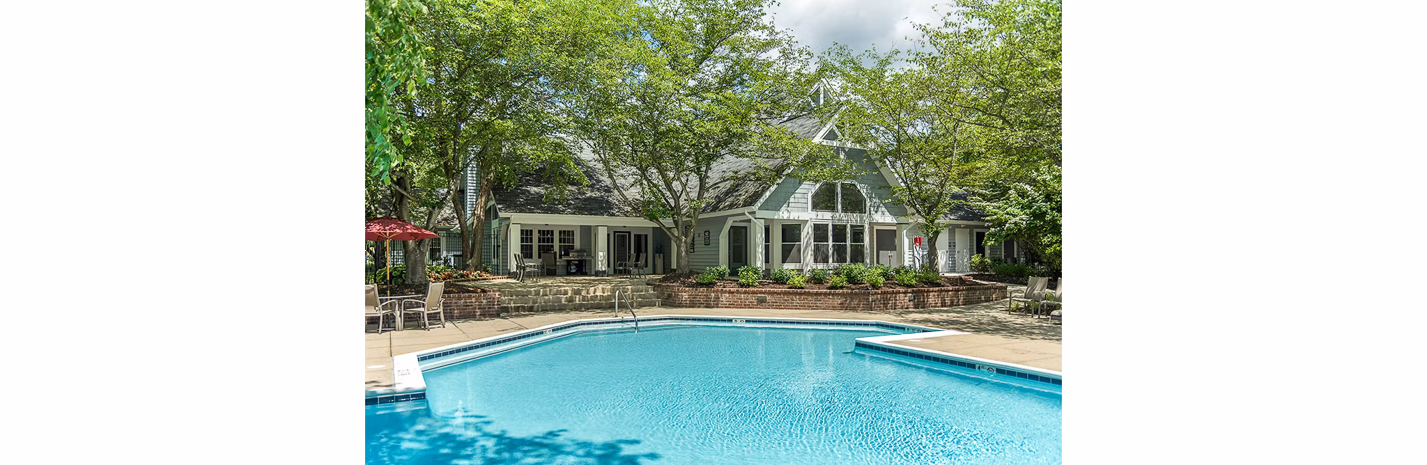 Resort-style pool with lounge chairs at Avana Heather Ridge Apartments