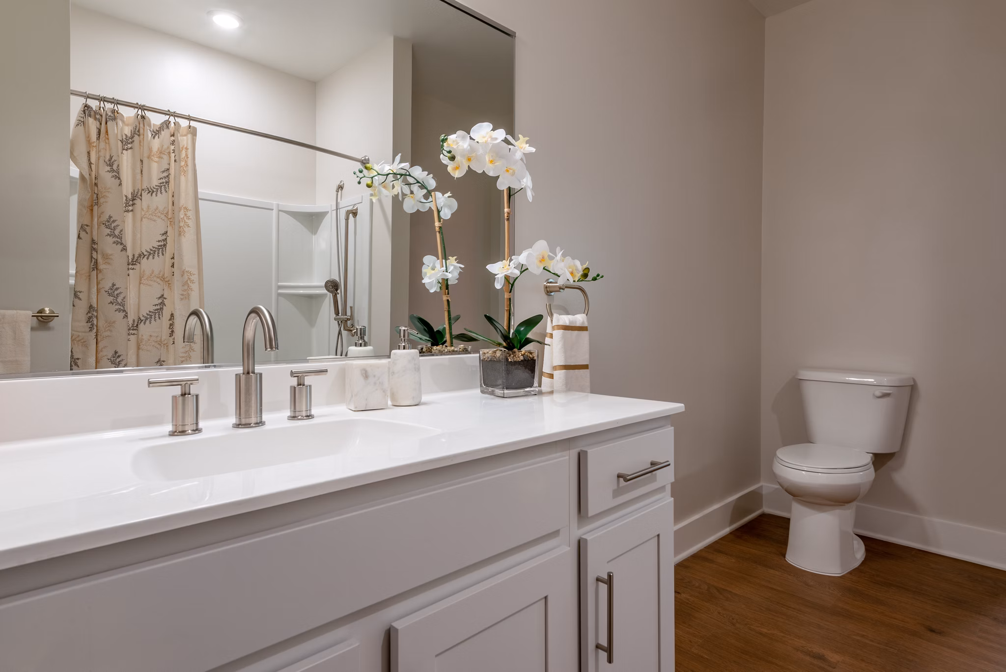 Stylish bathroom featuring a sleek sink and modern shower in luxury apartment