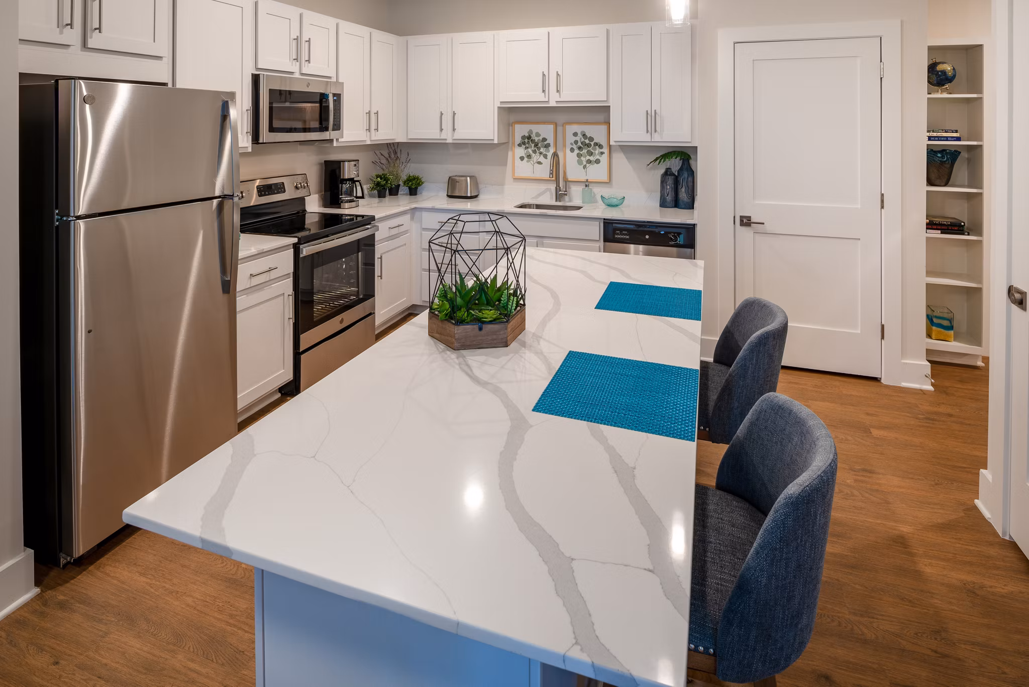 Modern kitchen with stainless steel appliances in Addison Row luxury apartments