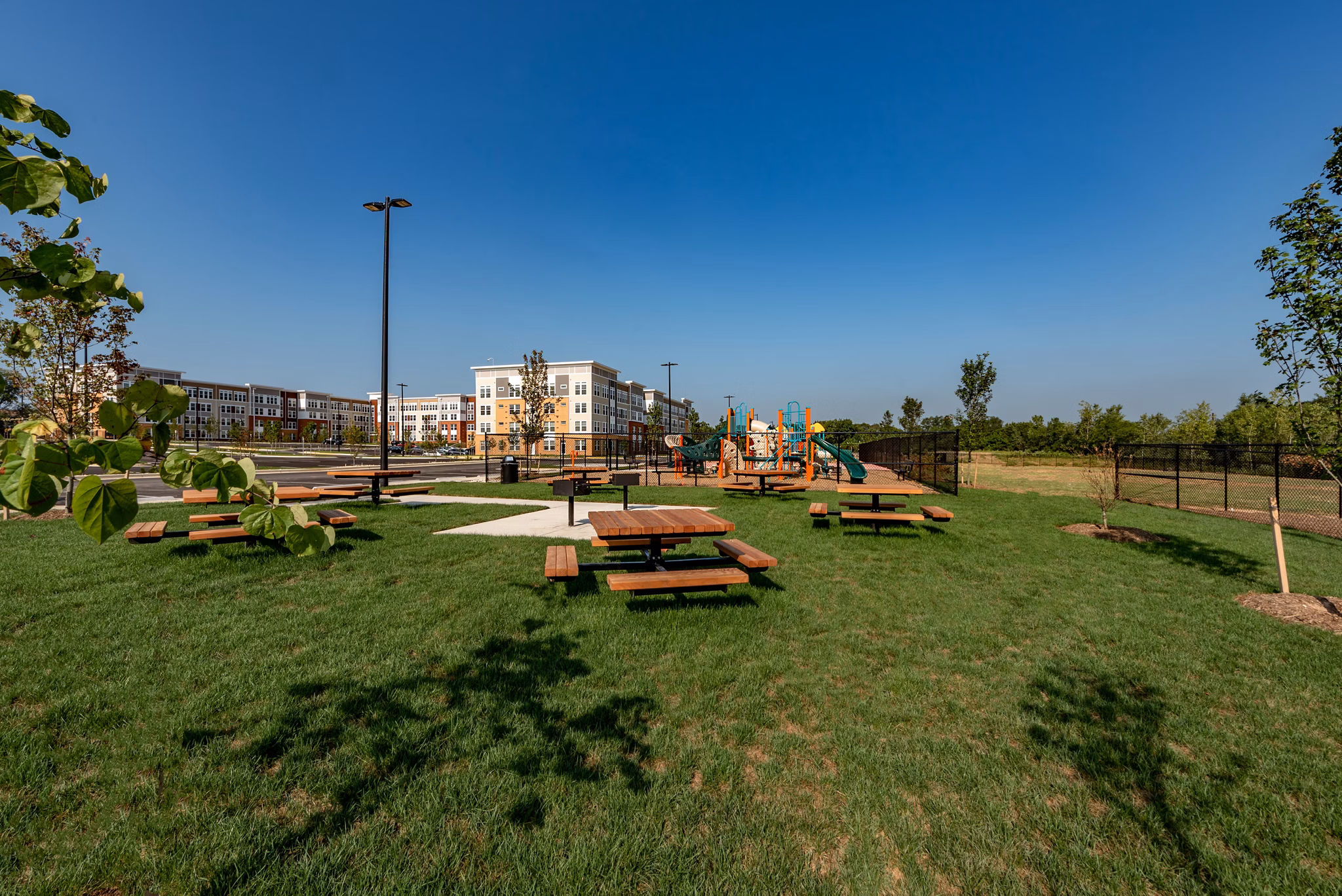 Outdoor terrace with seating and greenery at GS Addison Row luxury apartments