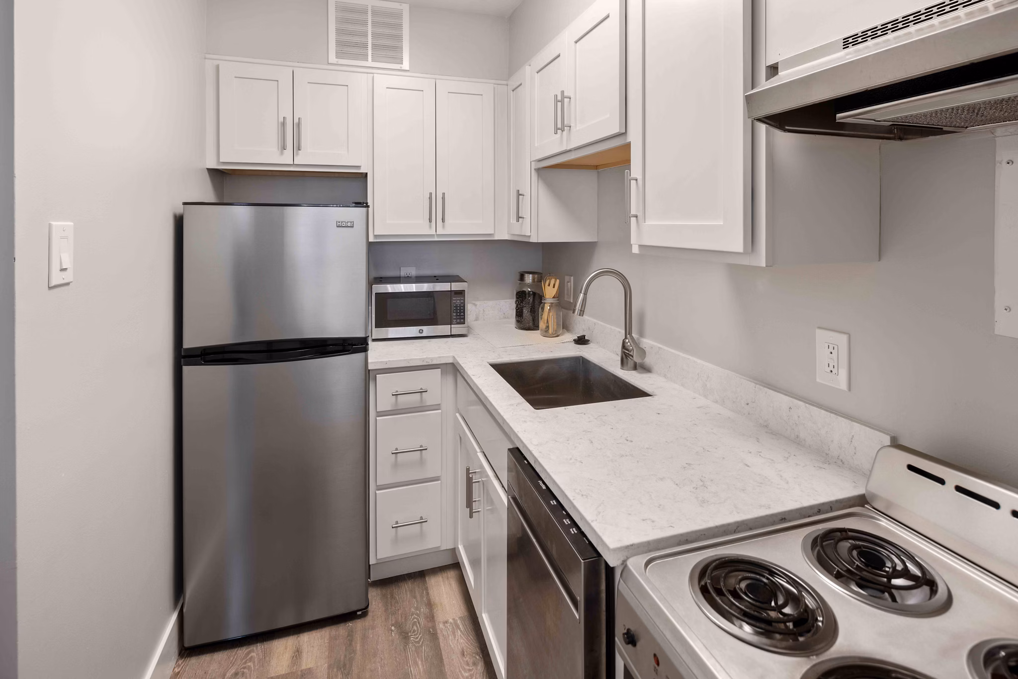Sleek modern kitchen with stainless steel appliances at The Luckman Apartments