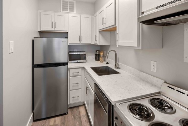 Sleek modern kitchen with stainless steel appliances at The Luckman Apartments