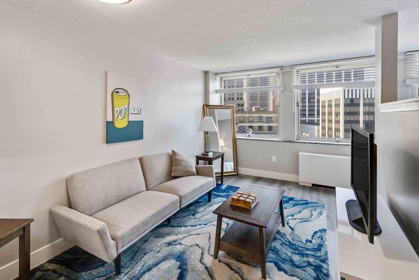 Spacious living room with modern decor in The Luckman Apartments