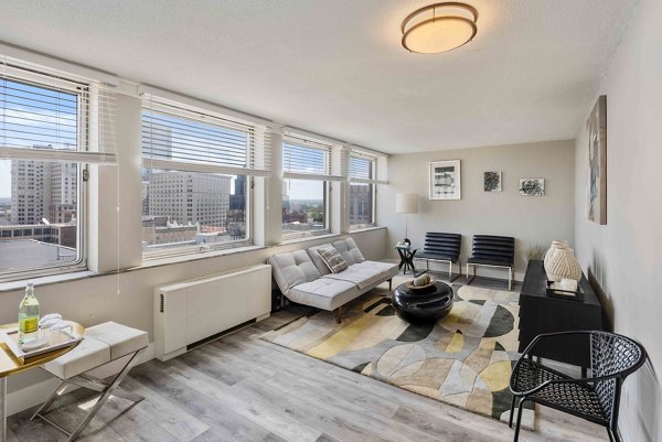 Spacious living room with stylish furnishings at The Luckman Apartments