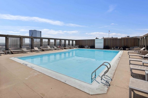 Luxurious outdoor pool with sundeck at The Luckman Apartments