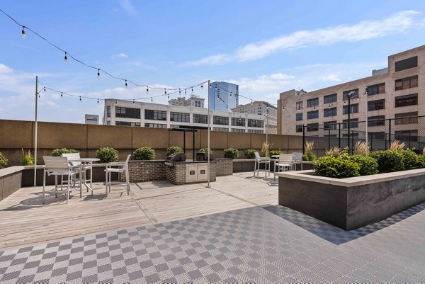 City-view rooftop deck at The Luckman Apartments, offering luxury relaxation spaces and panoramic vistas in a contemporary Greystar community