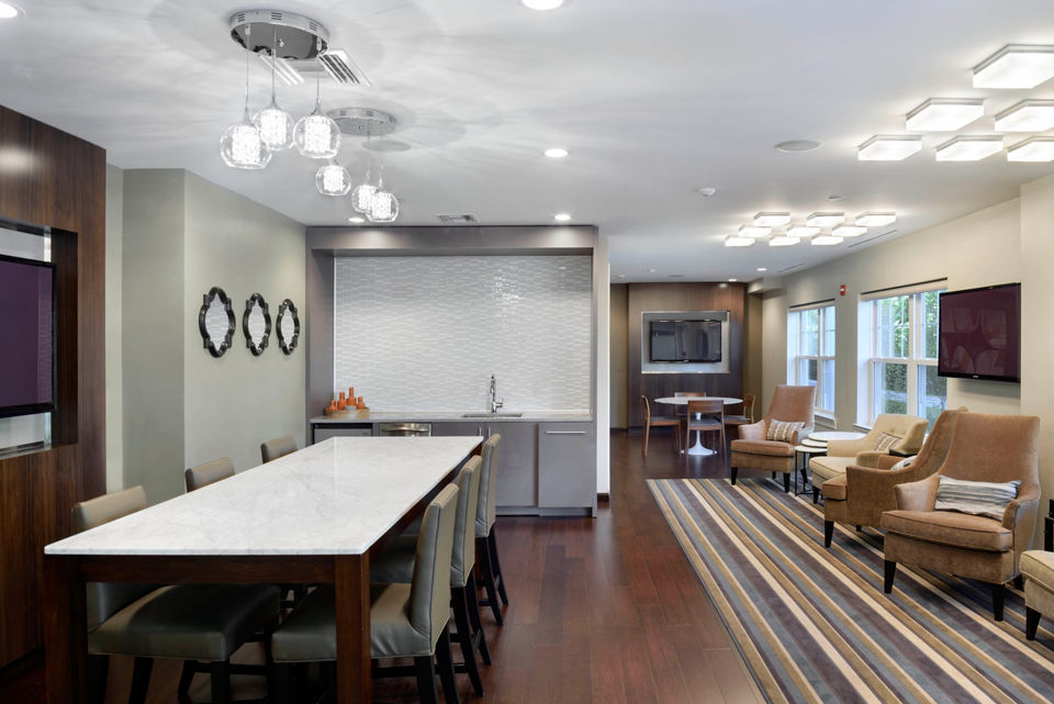 Clubhouse featuring modern design and cozy seating at The Village at Bronxville Apartments