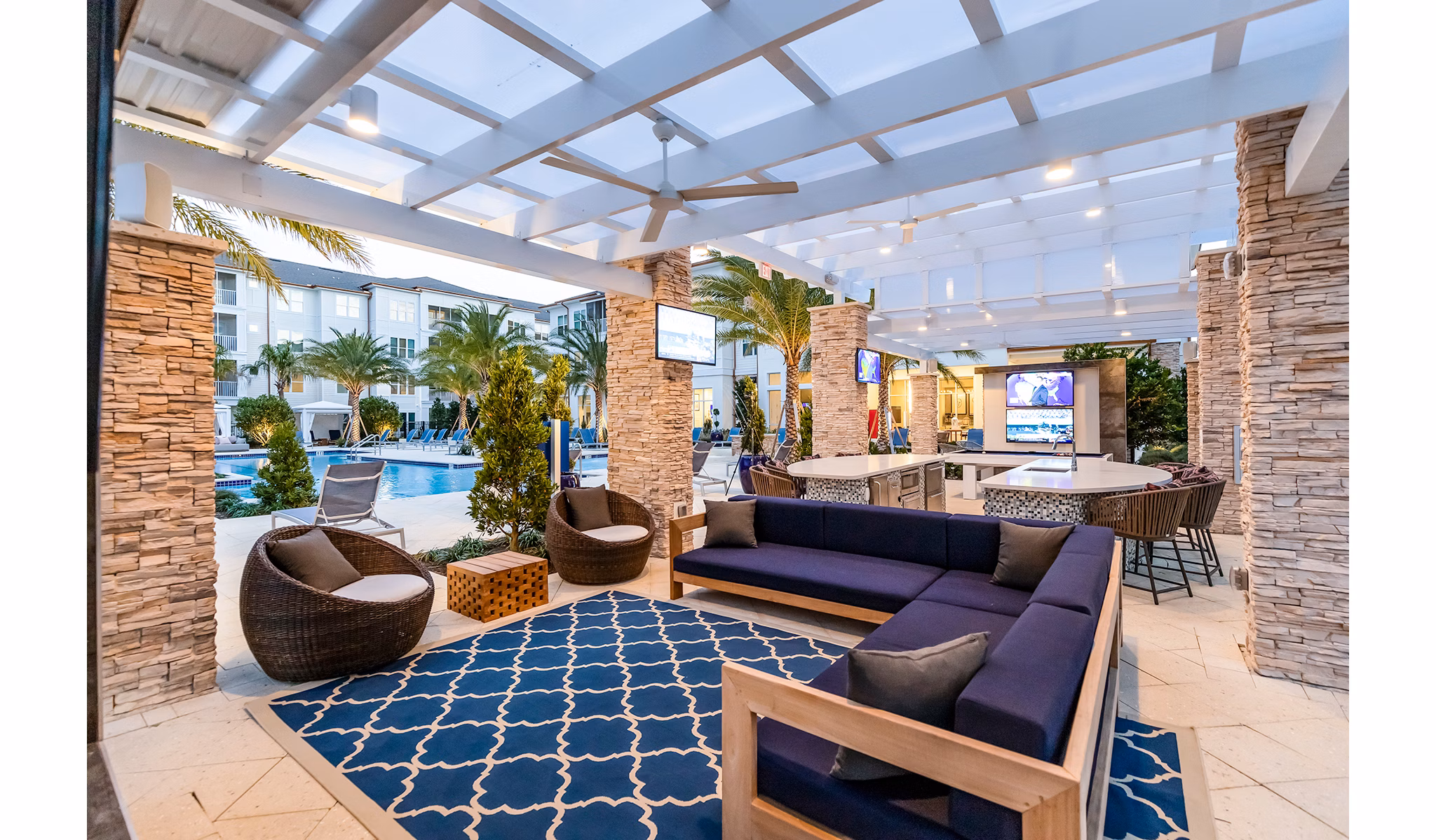Stylish pool patio with lounge chairs at Pier 8 at The Preserve Apartments