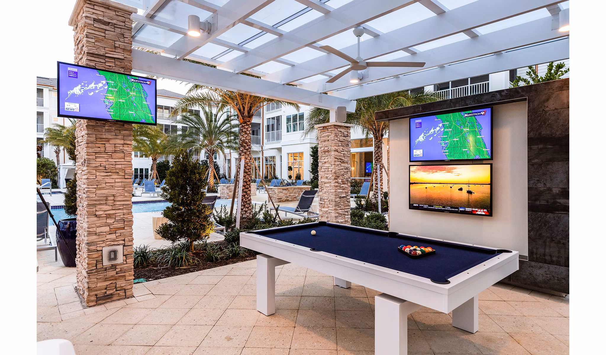 Pool and game room featuring modern amenities at Pier 8 at The Preserve Apartments, perfect for relaxation and entertainment