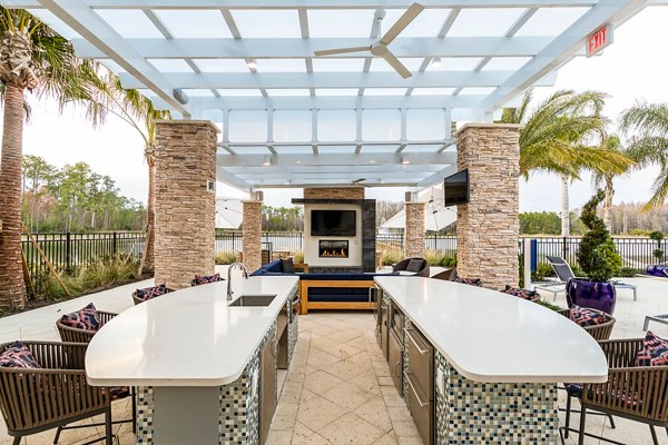 pool patio kitchen/fire pit area at Pier 8 at The Preserve Apartments