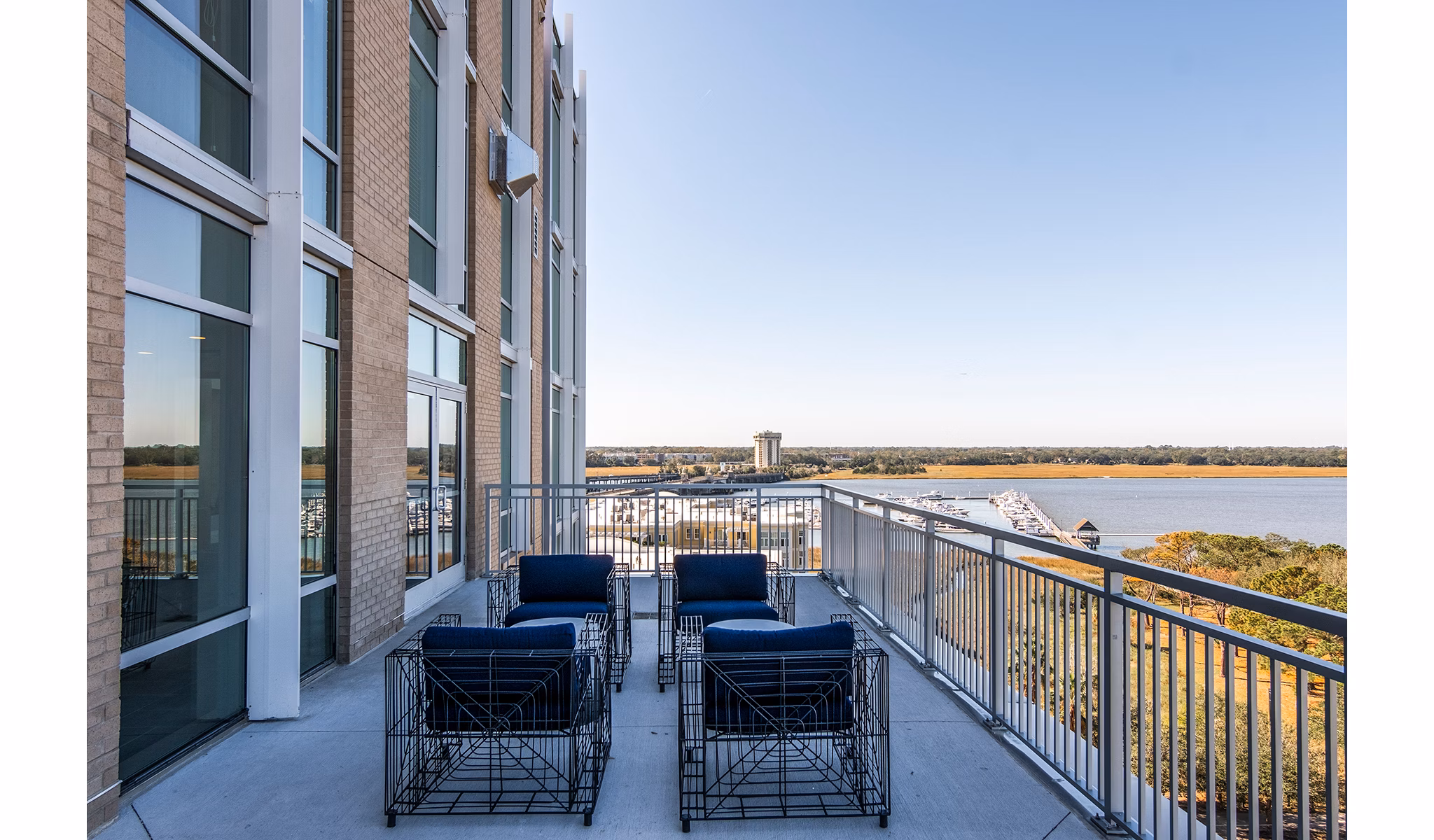 Chic clubhouse patio/balcony with river views at 10 WestEdge Apartments, perfect for outdoor gatherings and relaxation in luxury living
