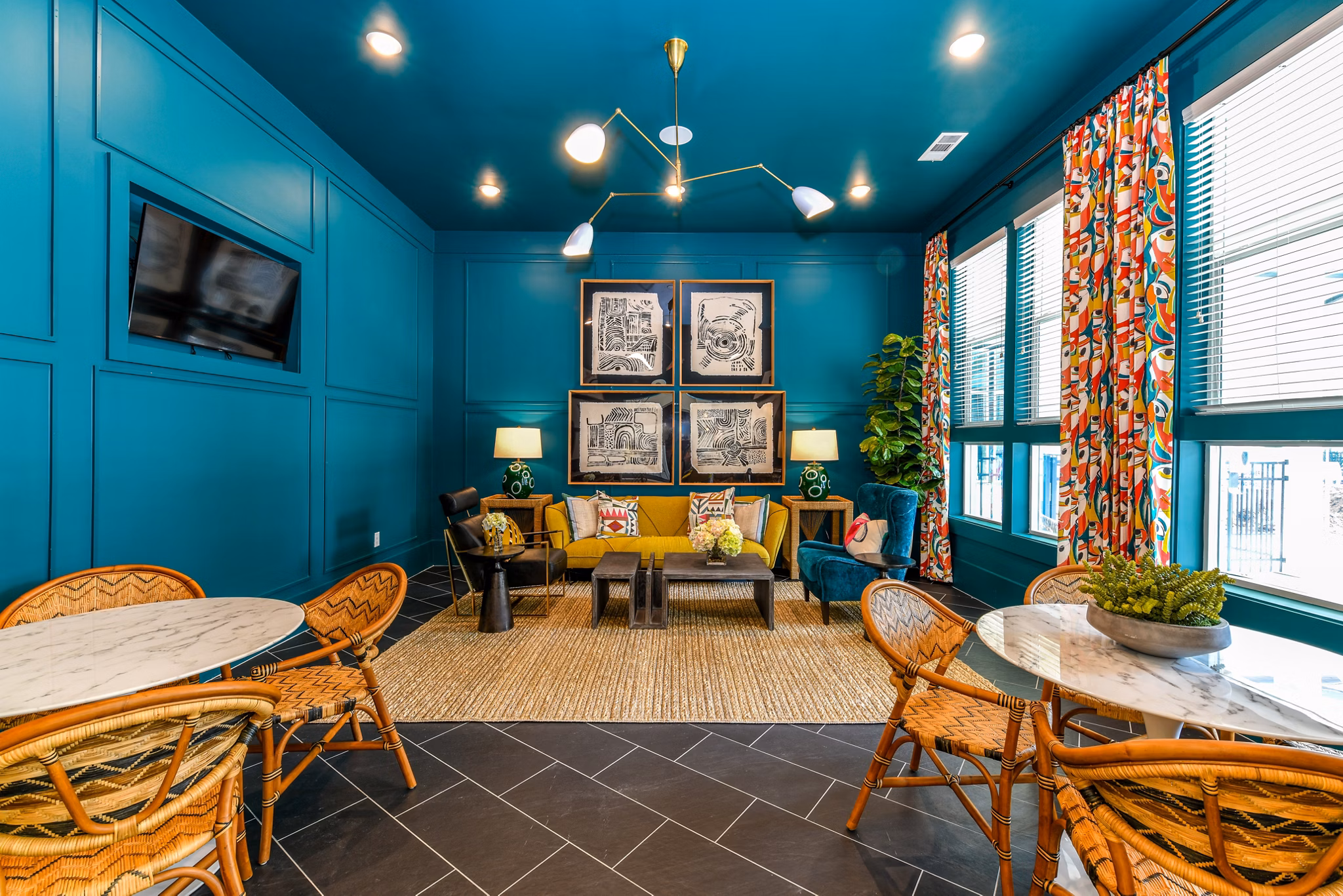 Clubhouse featuring modern decor and ample seating at Highland Exchange Apartments luxury community