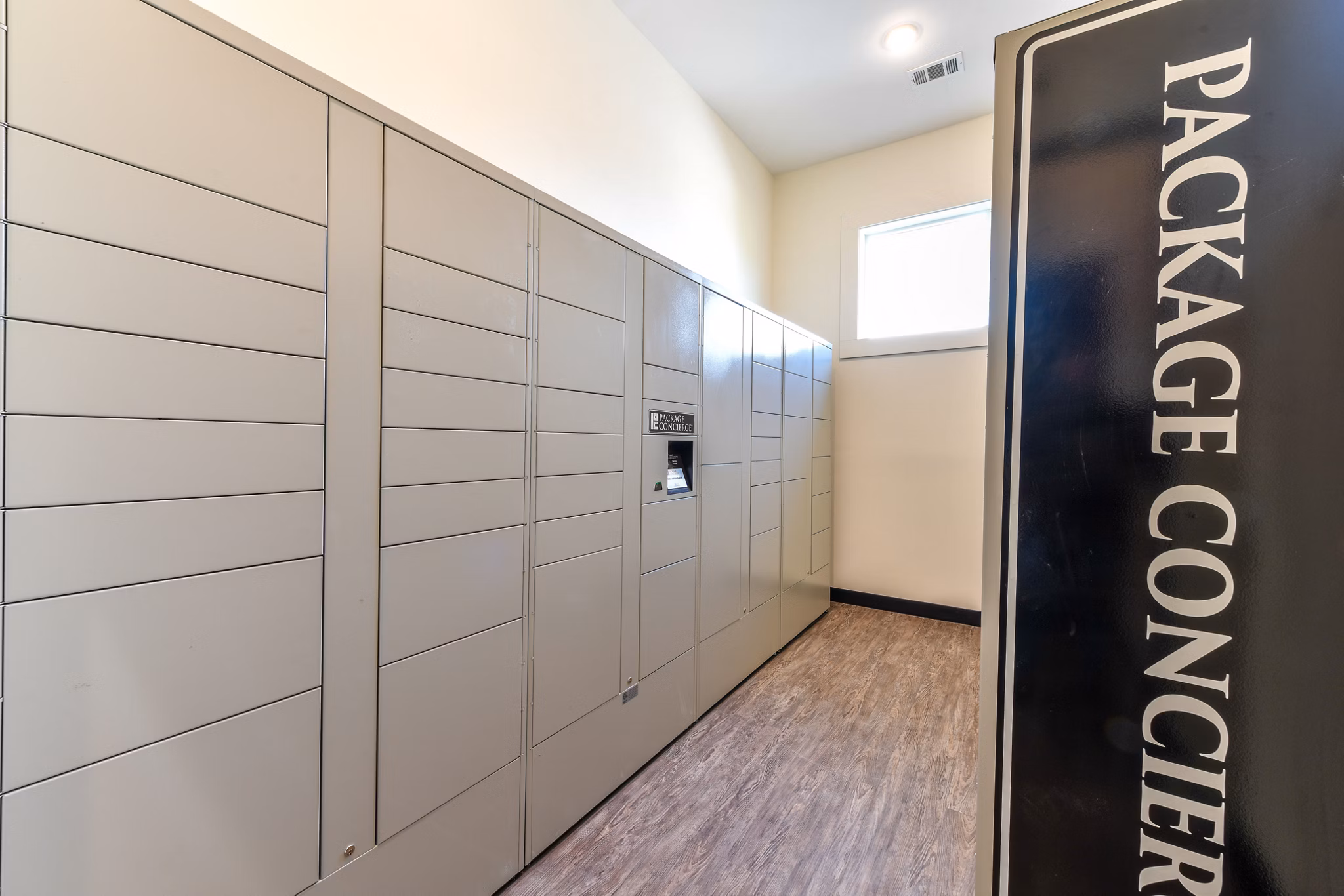 Modern mail room with secure package lockers at Highland Exchange Apartments