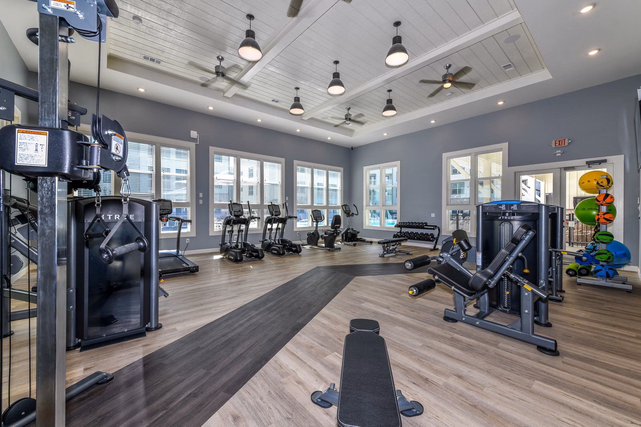 Modern fitness center with state-of-the-art equipment at Highland Exchange Apartments