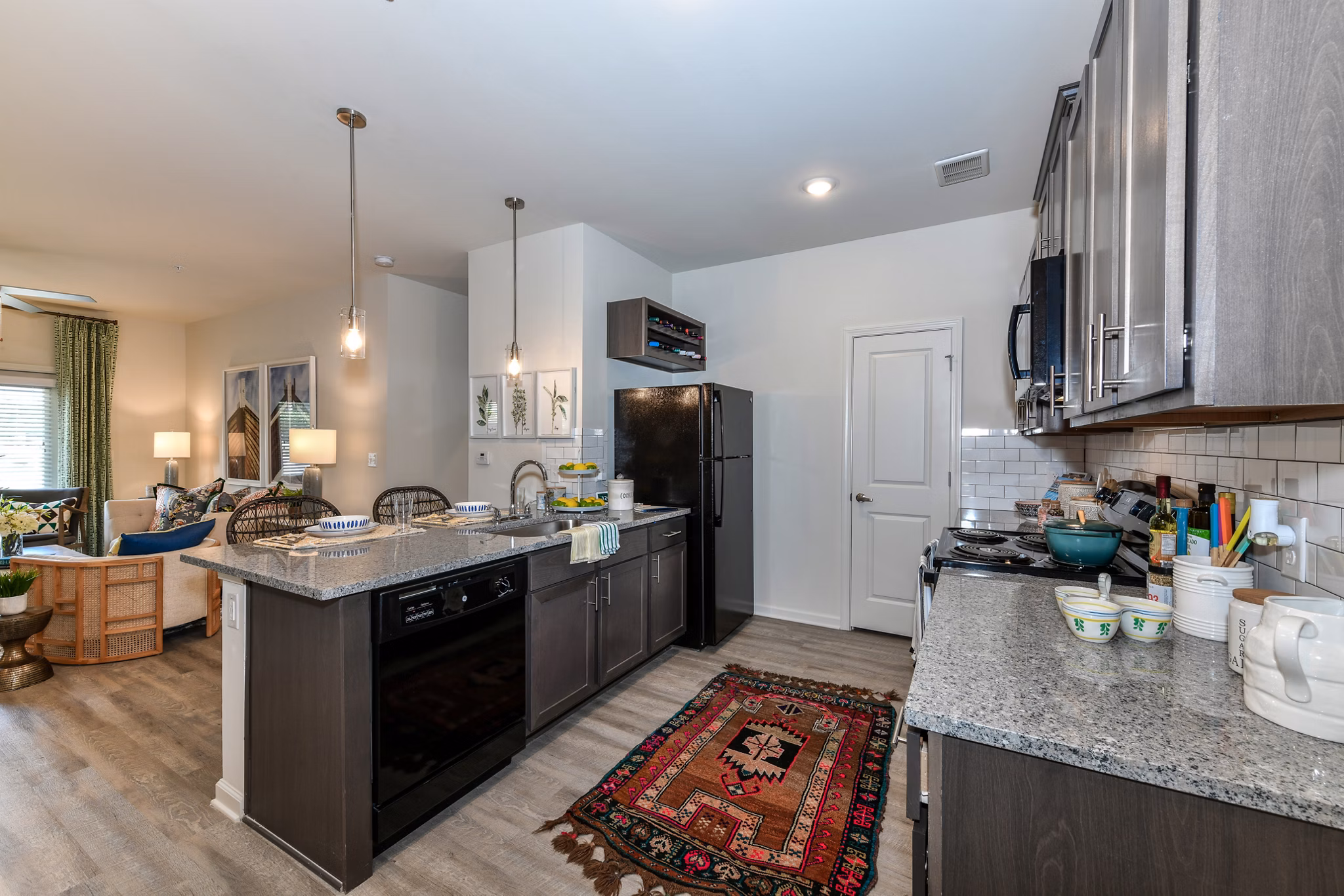 Modern kitchen with stainless steel appliances at Highland Exchange Apartments