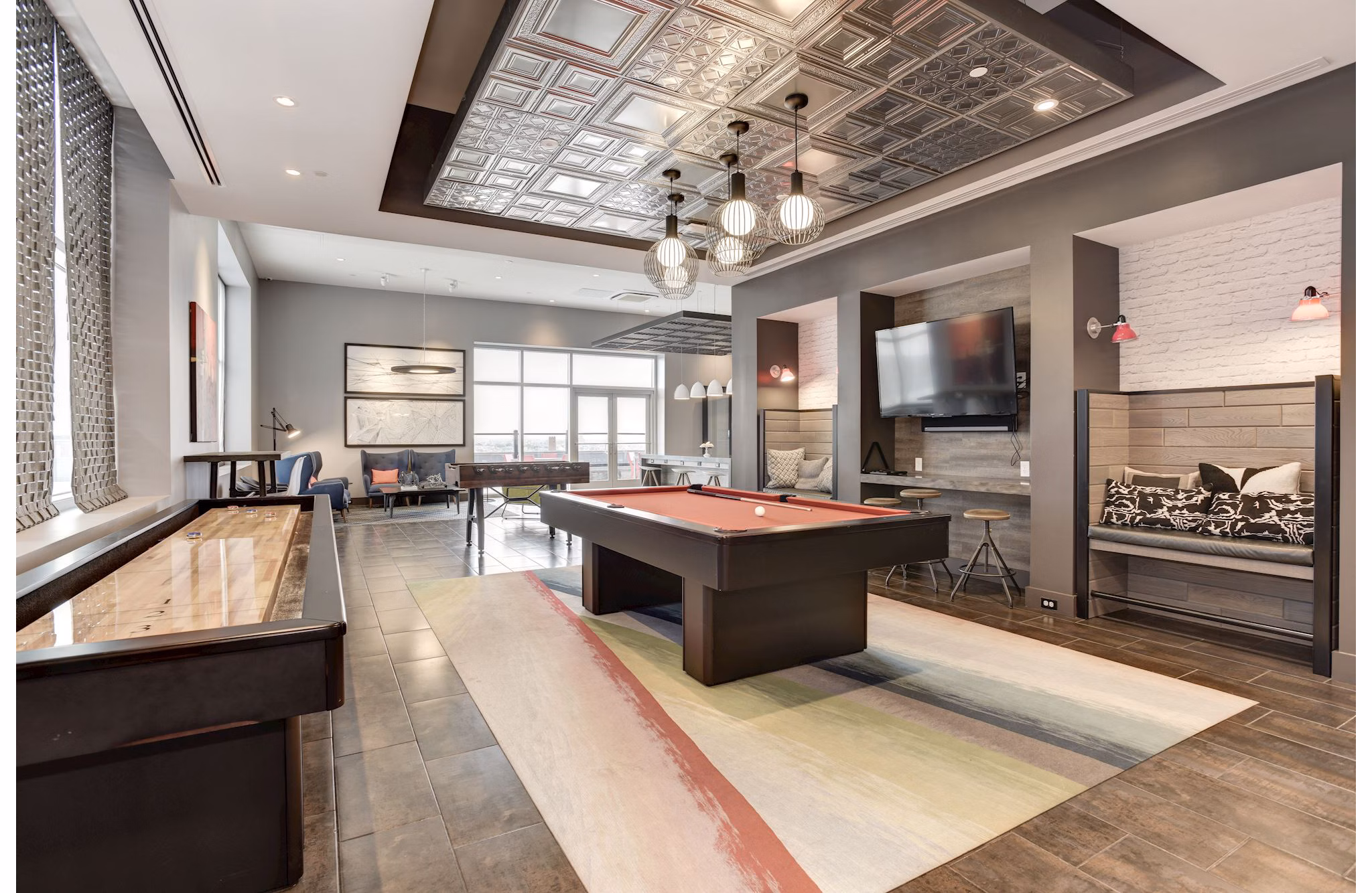 Clubhouse game room with pool table at 225 N Calvert Apartments, luxury living by Greystar