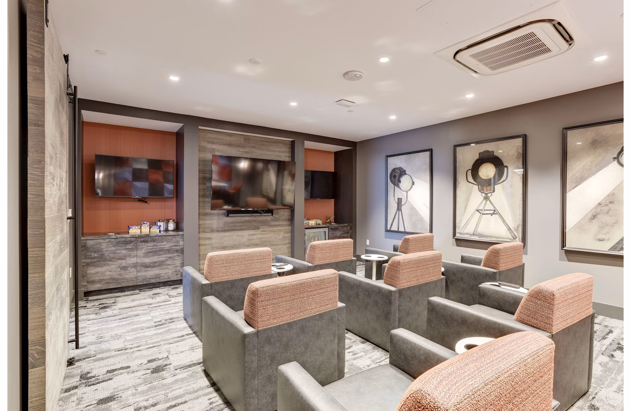 Theater room with plush seating and large screen at 225 N Calvert Apartments, a Greystar luxury property in Baltimore