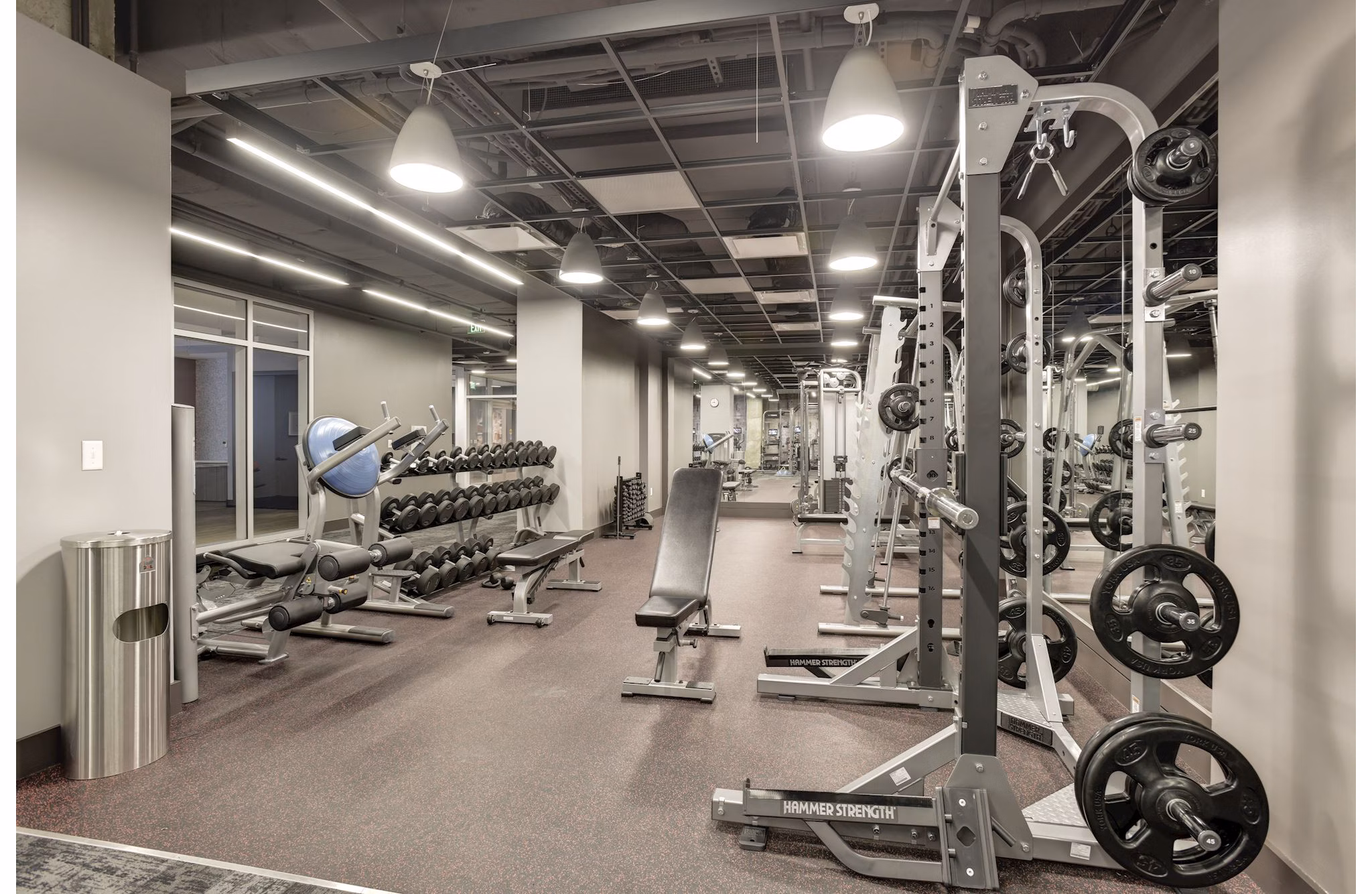 Fitness center with modern equipment at 225 N Calvert Apartments offering a luxurious workout experience