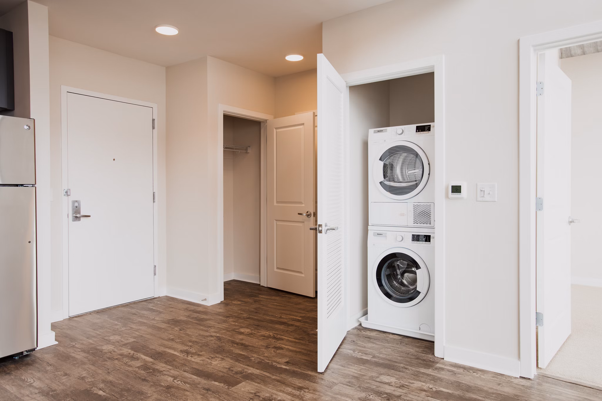 Laundry room featuring stackable washer and dryer at 225 N Calvert Apartments