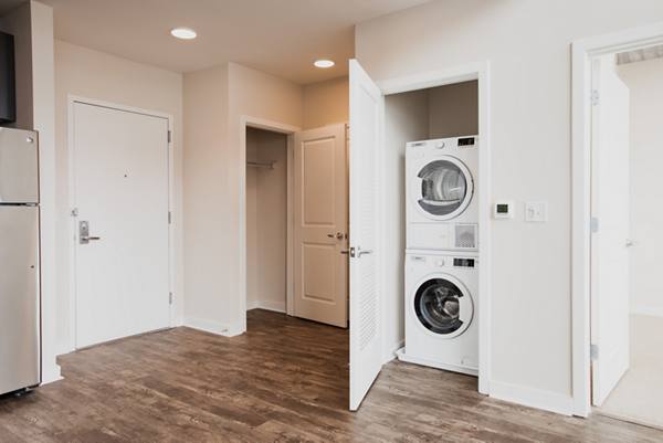 laundry room with stackable washer and dryer at 225 N Calvert Apartments