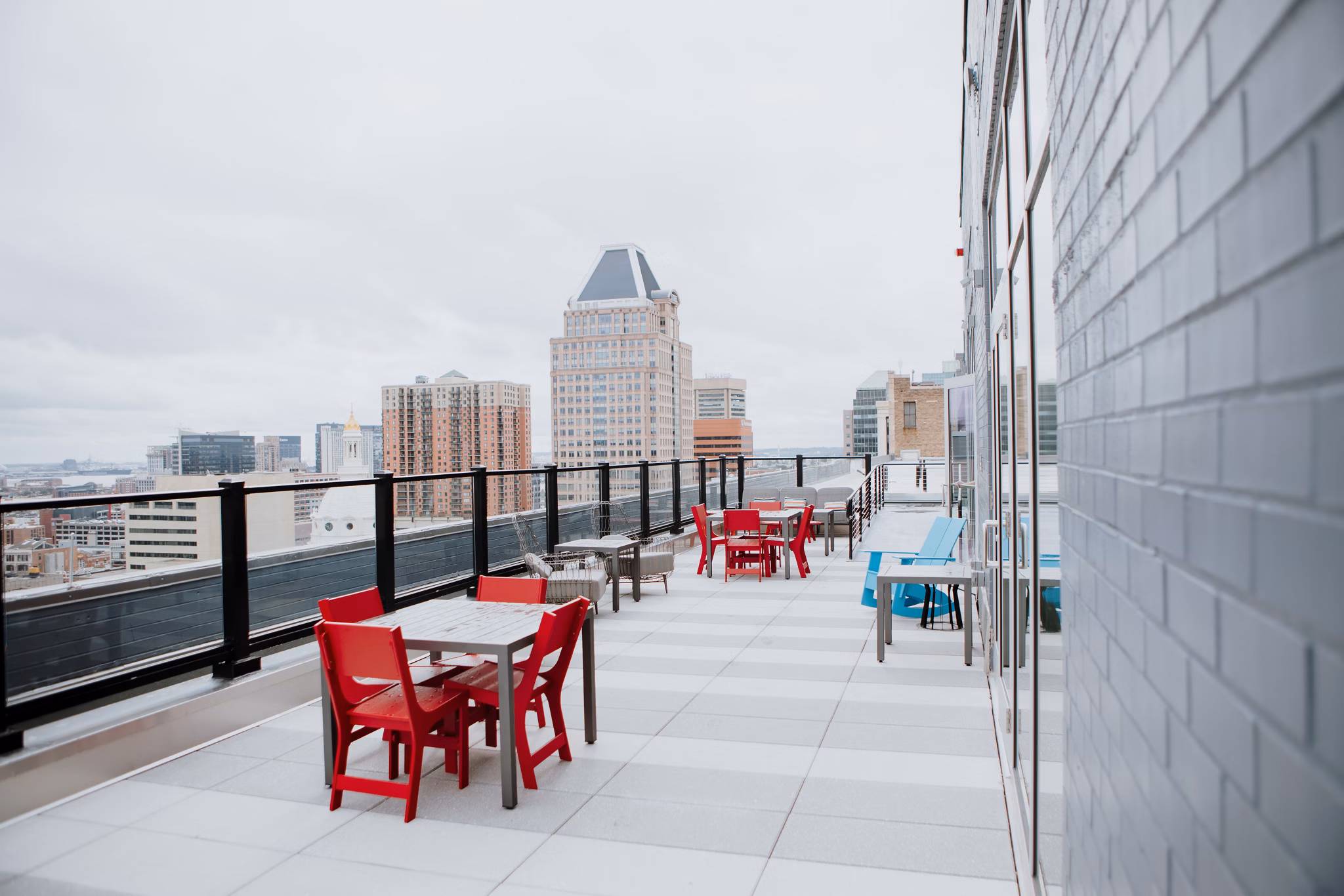 Rooftop deck with seating offering city views at 225 N Calvert Apartments