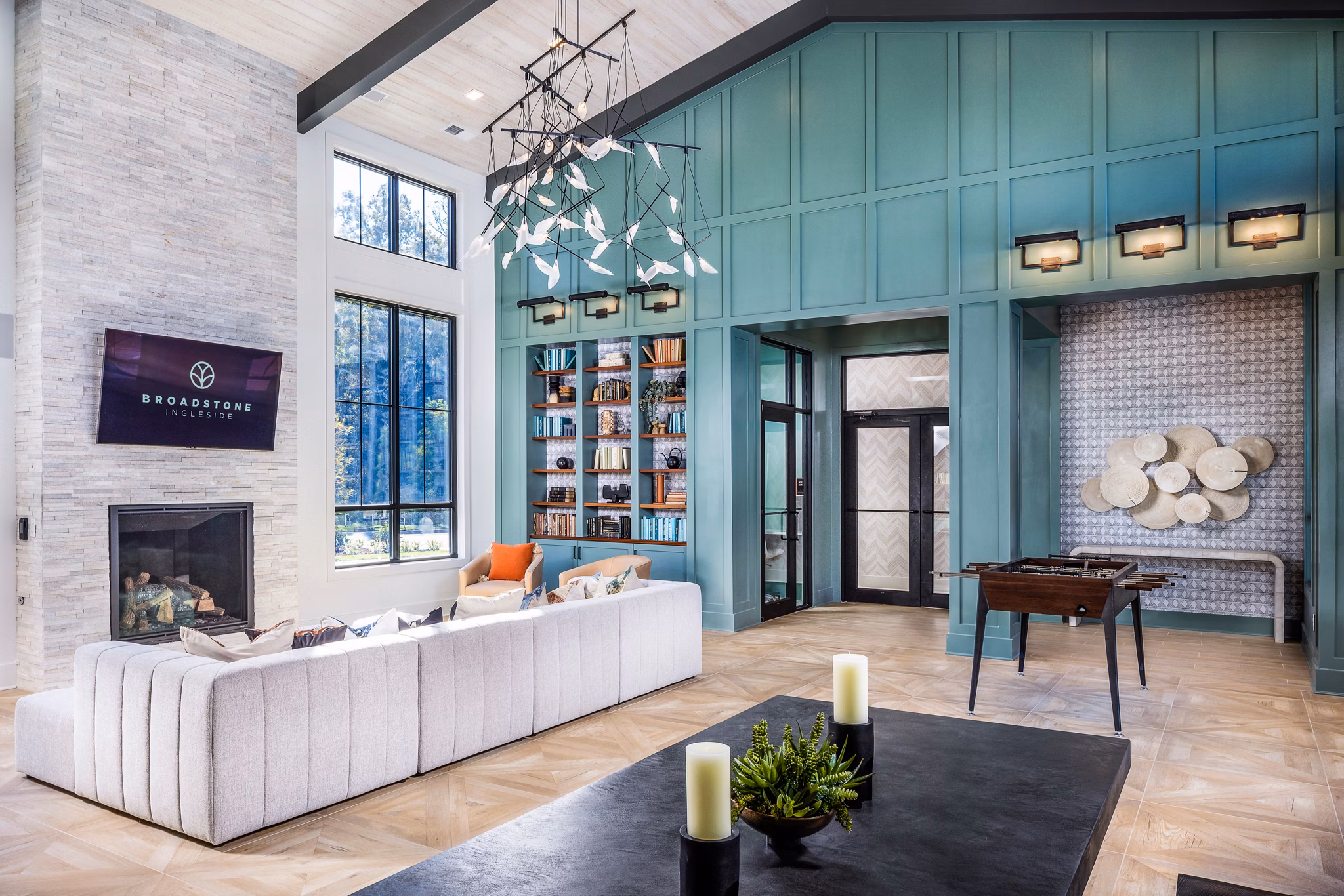 Modern clubhouse featuring lounge seating and games at Broadstone Ingleside Apartments