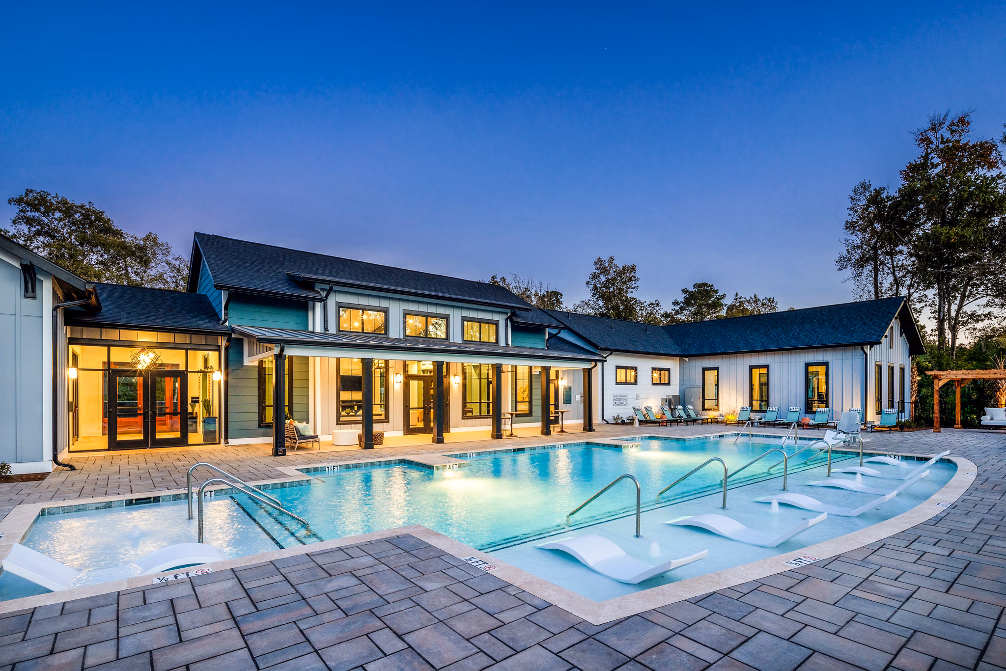 Inviting outdoor pool area at Broadstone Ingleside Apartments with sun loungers and lush landscaping, perfect for relaxation and leisure activities