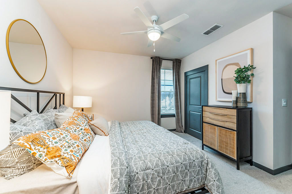 Cozy bedroom featuring modern furnishings and plush bedding at The Reserve at Venice Apartments