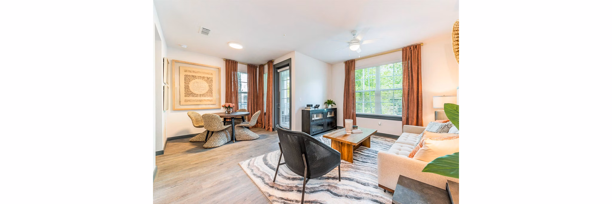 Elegant living room with modern furnishings and large windows at The Reserve at Venice Apartments