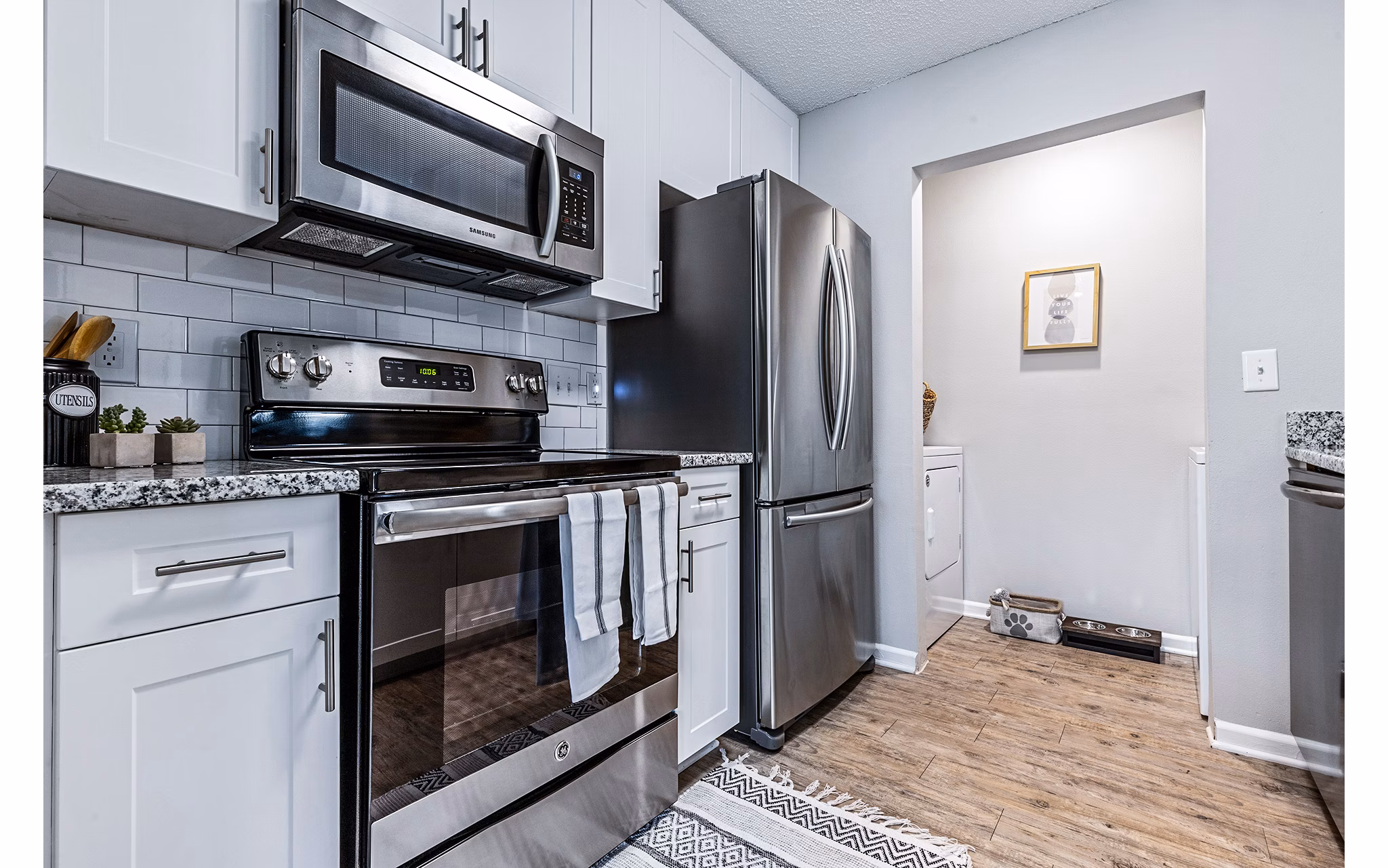 Modern kitchen with stainless steel appliances and granite countertops at Vista Commons Apartments