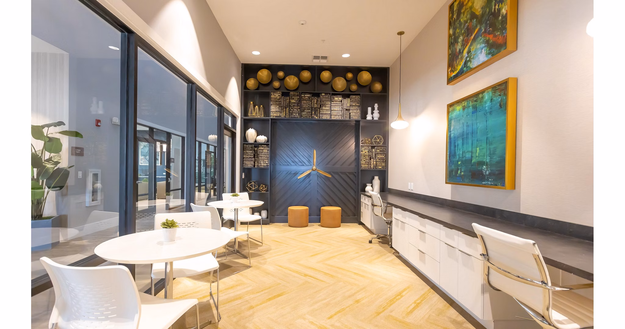 Modern clubhouse with ample seating and entertainment options at Calirosa Apartments
