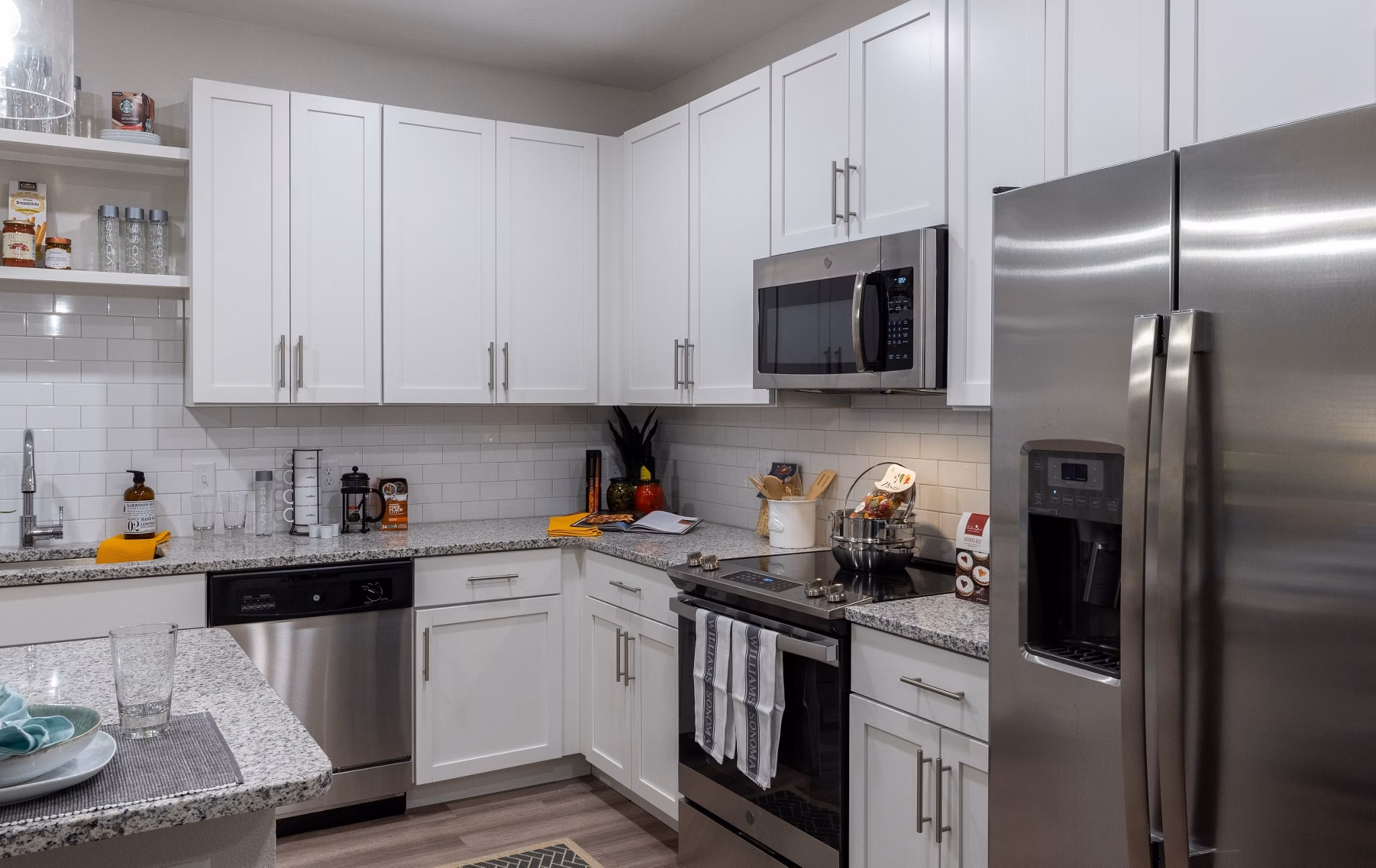 Modern kitchen featuring sleek countertops and stainless steel appliances in Calirosa Apartments luxury complex