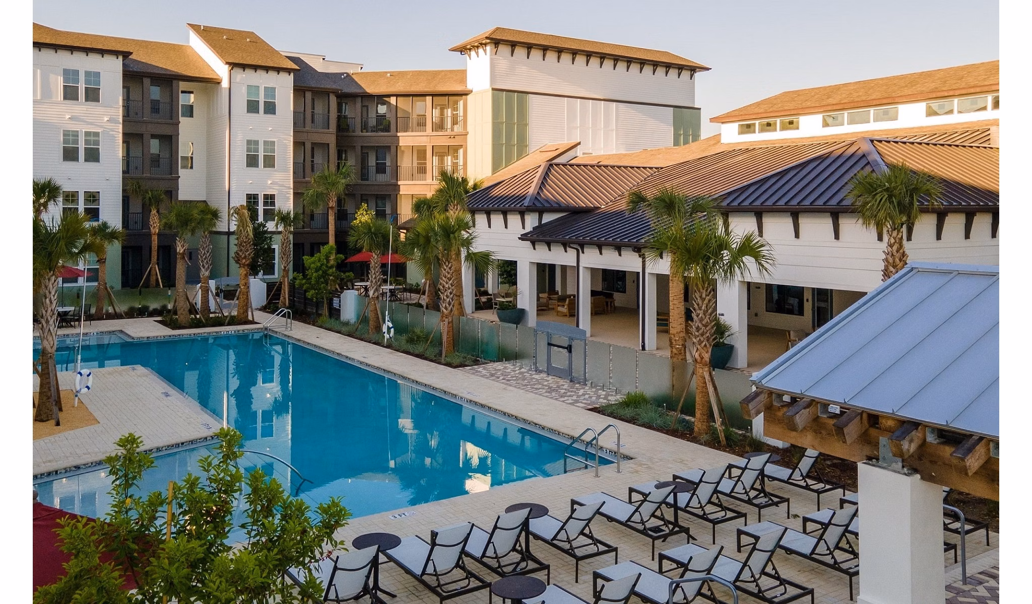 Luxury poolside oasis at Calirosa Apartments featuring cabanas and lounge seating