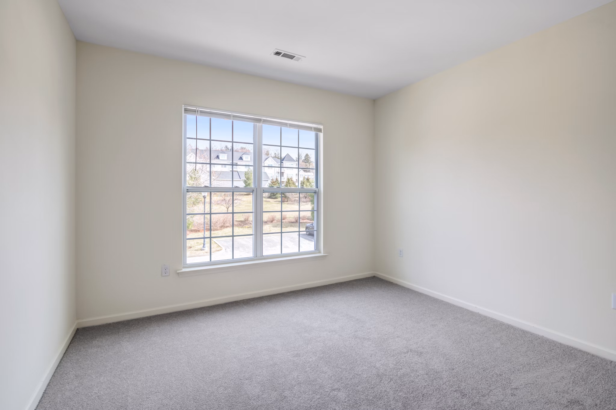 Bedroom with modern design and large windows at Terraces on the Hudson Apartments