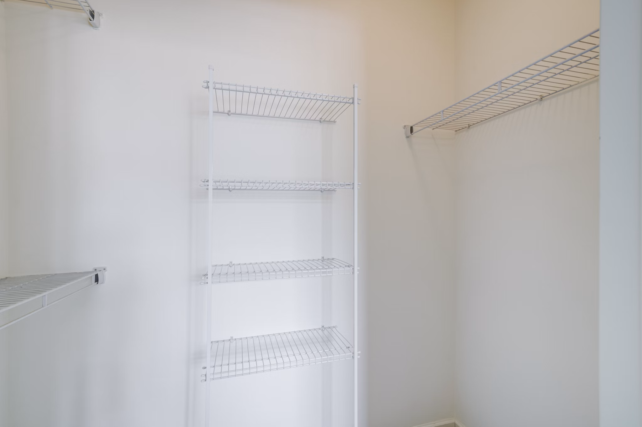 Walk-in closet with spacious shelving at Terraces on the Hudson Apartments