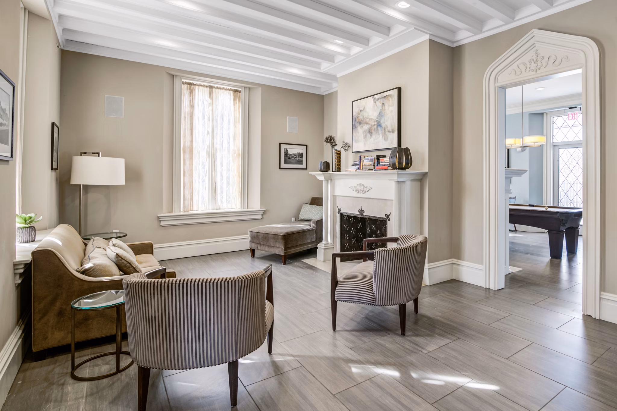 Modern clubhouse with plush seating and large windows at Terraces on the Hudson Apartments