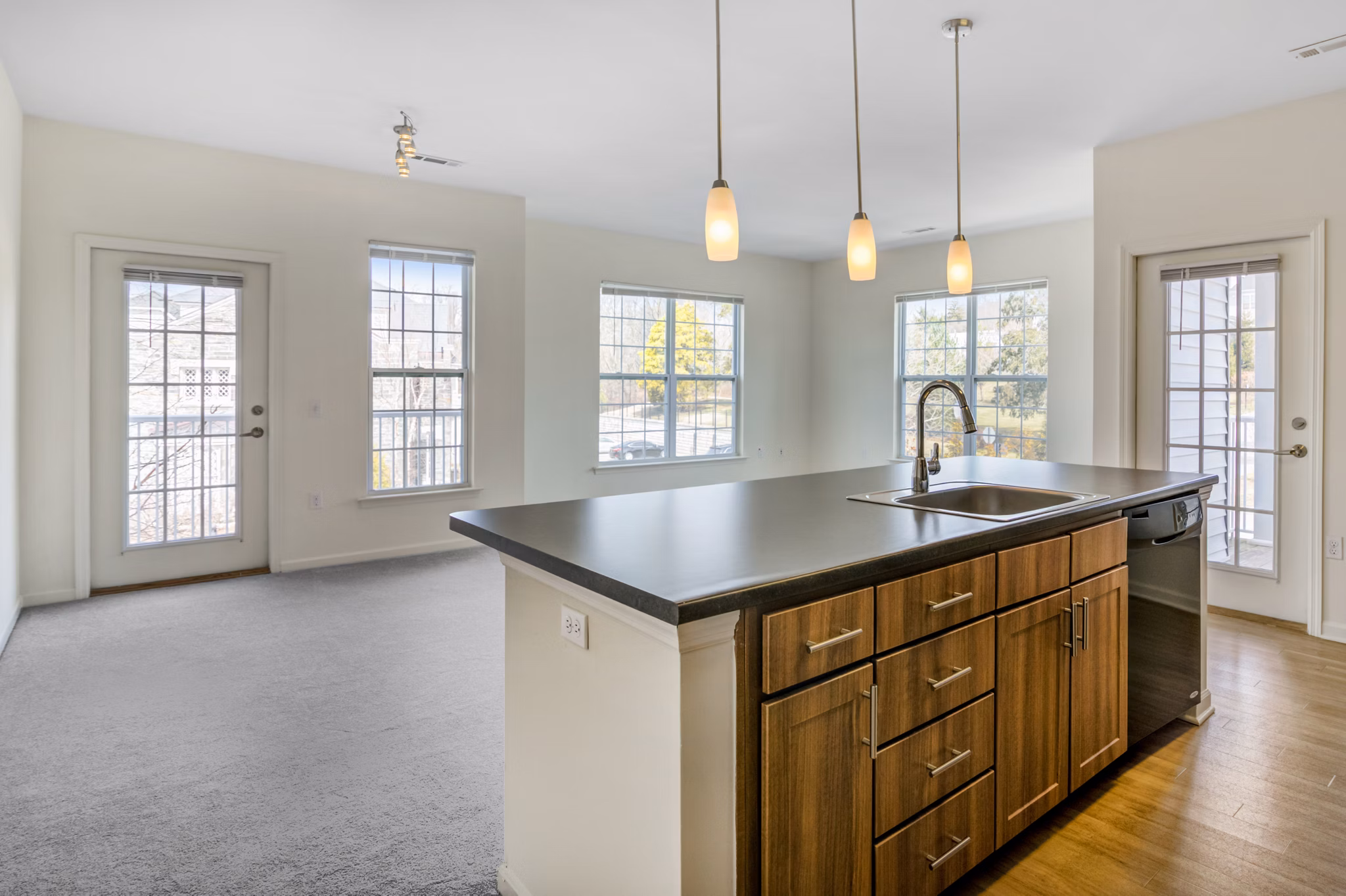 Modern kitchen with stainless steel appliances and granite countertops at Terraces on the Hudson Apartments