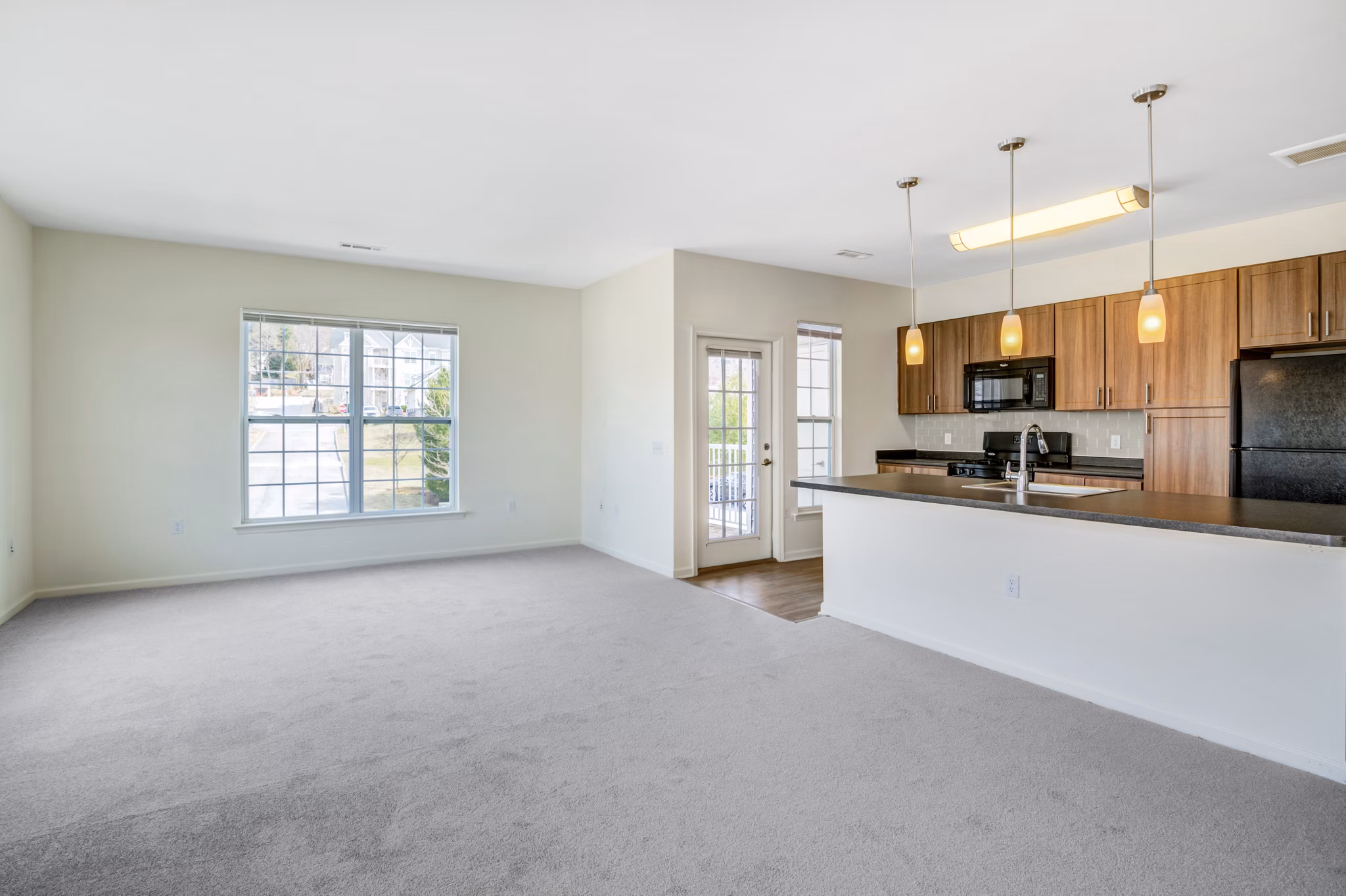 Modern living room with stylish decor and large windows at Terraces on the Hudson Apartments