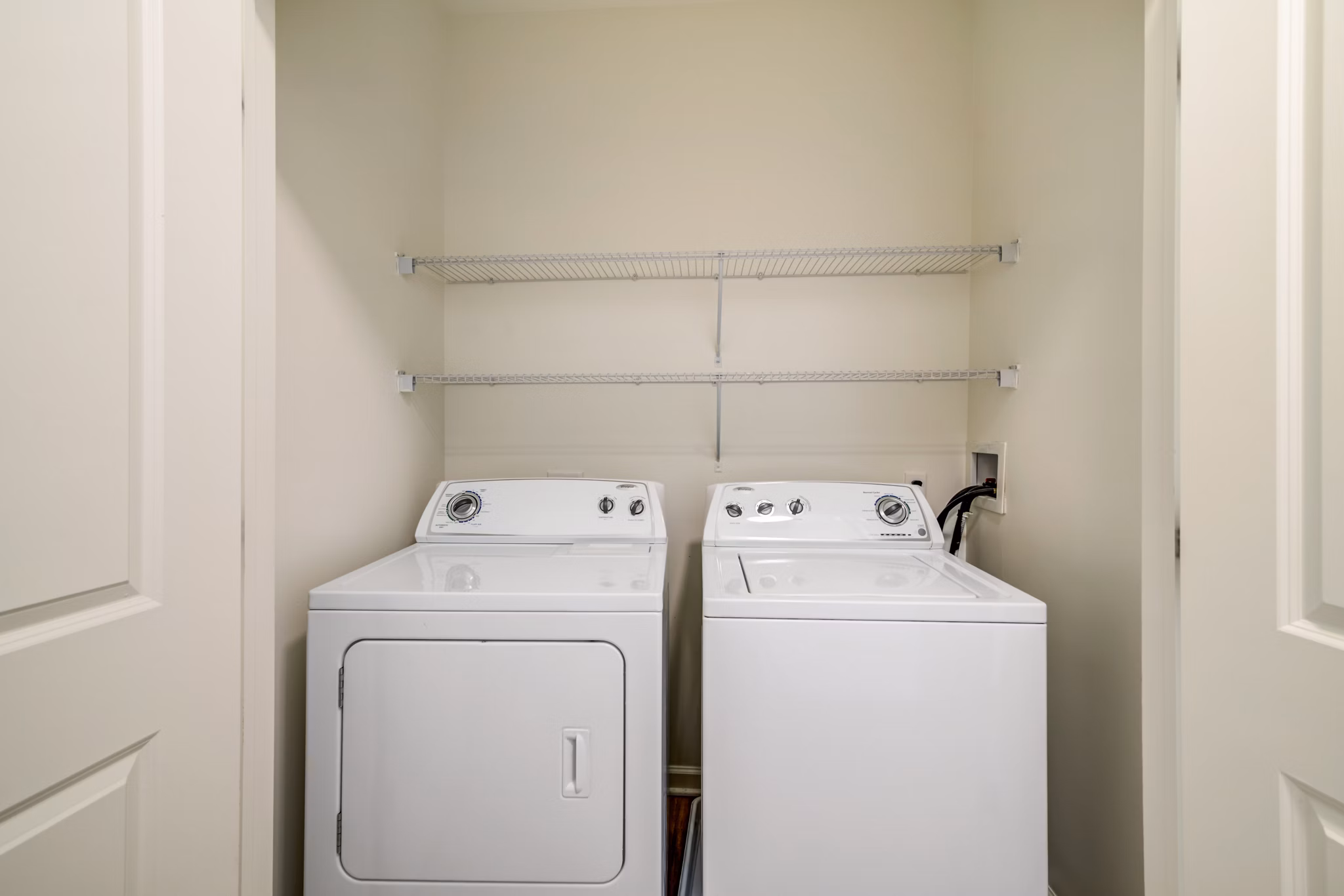 Laundry room with modern appliances at Terraces on the Hudson Apartments, featuring luxury amenities in a Greystar community