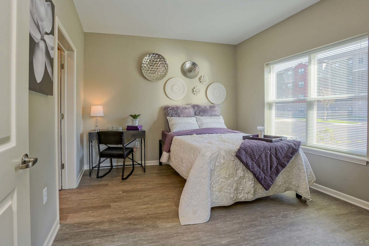 Modern bedroom with stylish decor and ample natural light at Monarch 716 Apartments, a Greystar luxury apartment community