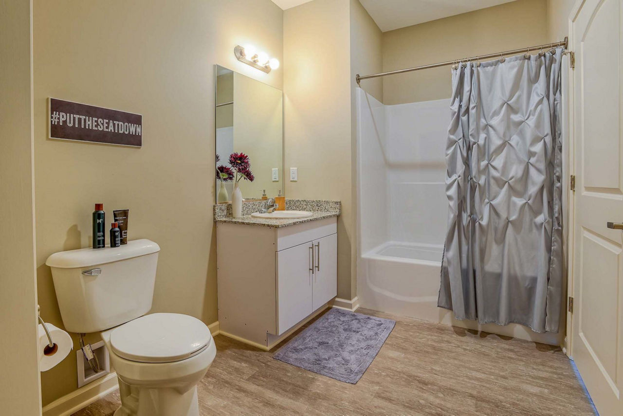 Modern bathroom with sleek fixtures and elegant lighting at Monarch 716 Apartments luxury suites