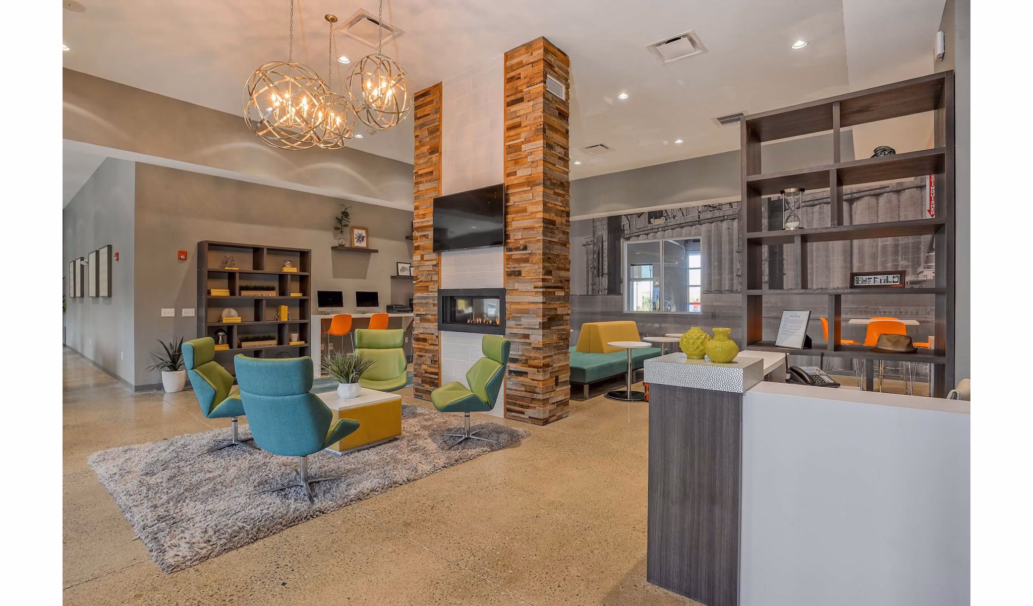 Modern clubhouse with stylish seating and large TV at 101 Center Apartments