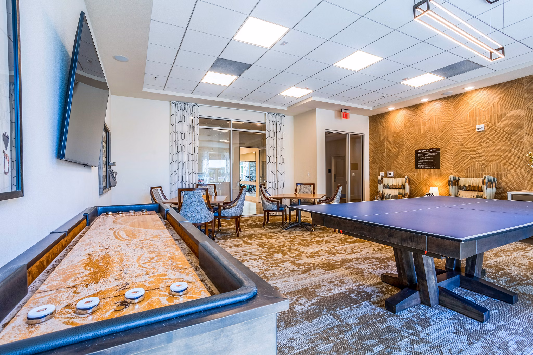 Game room with billiards and lounge seating at Larkspur at Shadow Creek Apartments, a luxury community