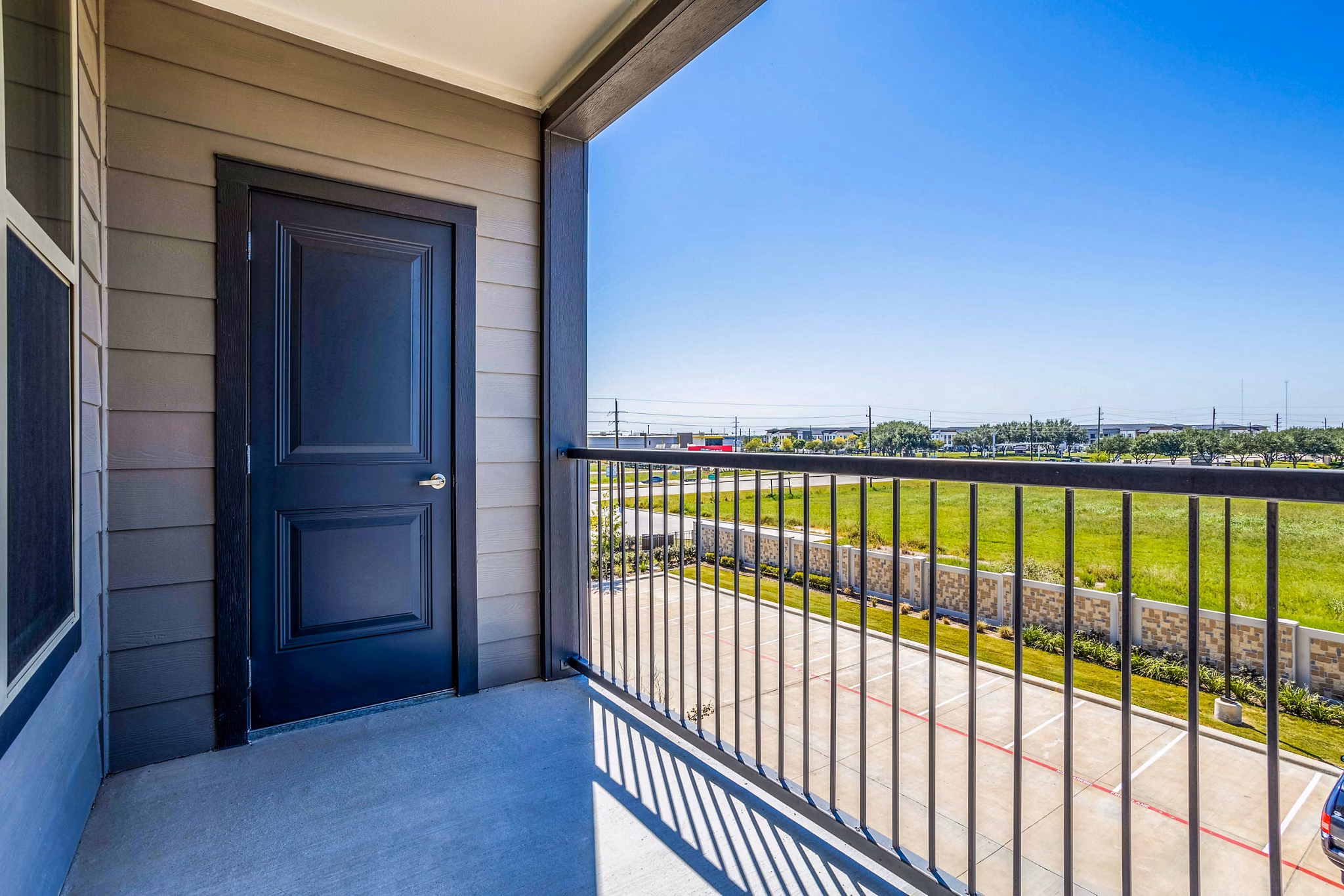 Patio with cozy seating and potted plants at Larkspur at Shadow Creek Apartments