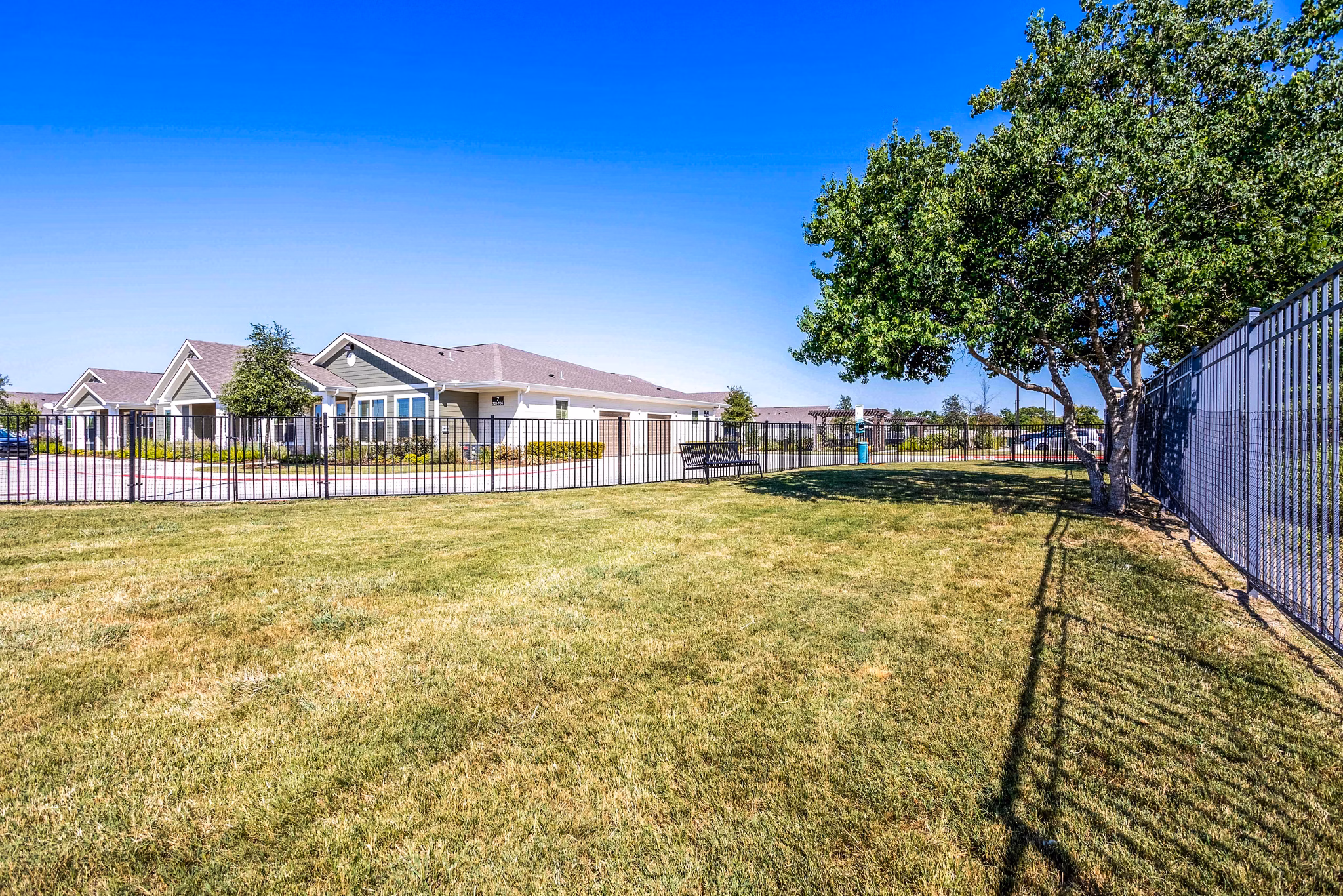 Off-leash dog park with green space at Larkspur at Shadow Creek Apartments, ideal for pet-friendly luxury living