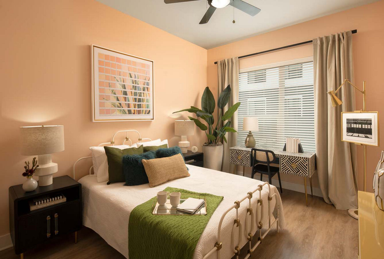 Bedroom featuring modern decor and a large window at Novel Midtown Tampa Apartments