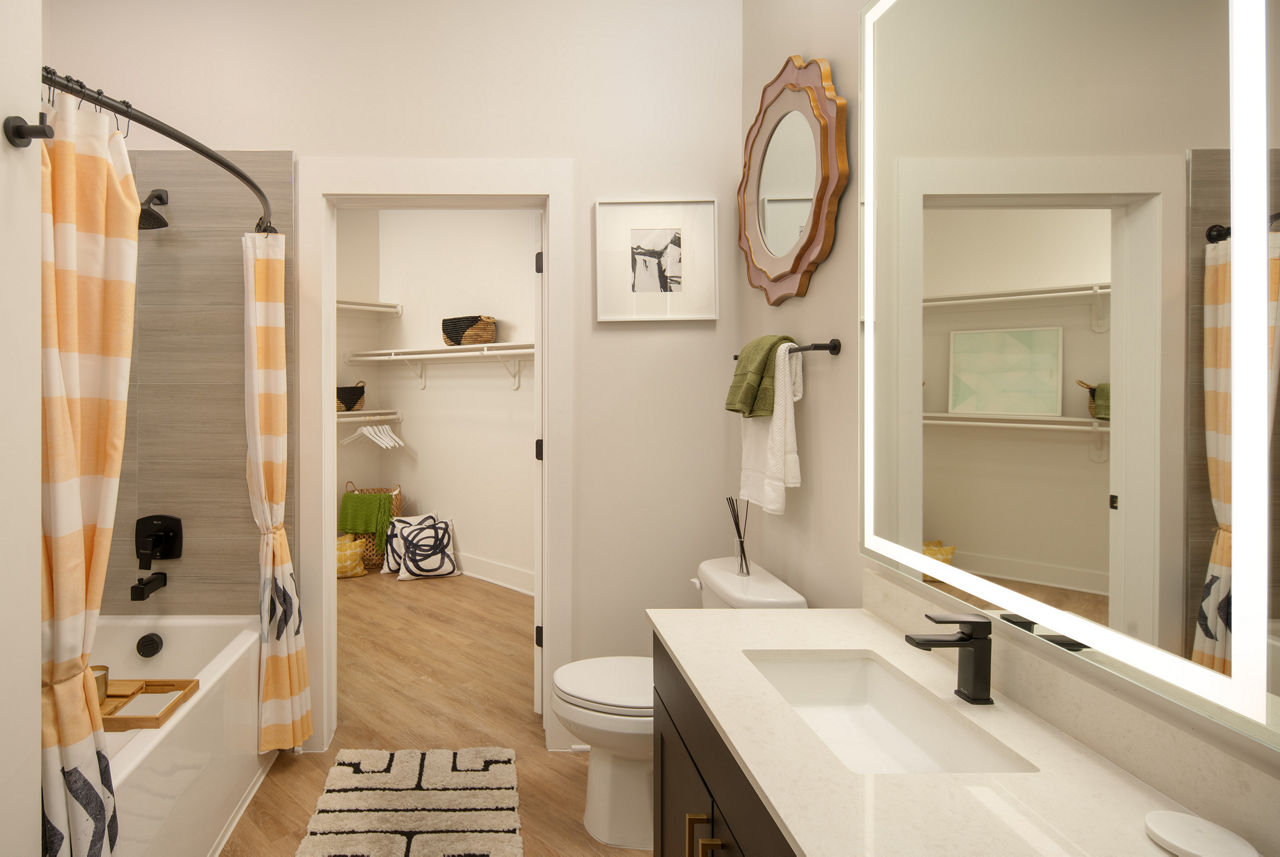 Bathroom featuring modern fixtures and marble countertops at Novel Midtown Tampa Apartments, a luxurious property by Greystar