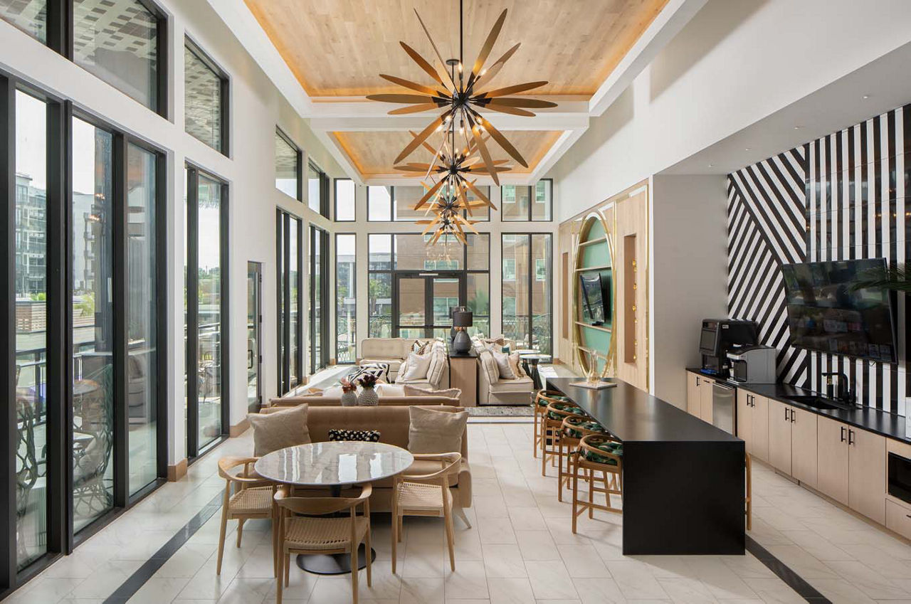 Modern clubhouse with stylish seating and pool table at Novel Midtown Tampa Apartments